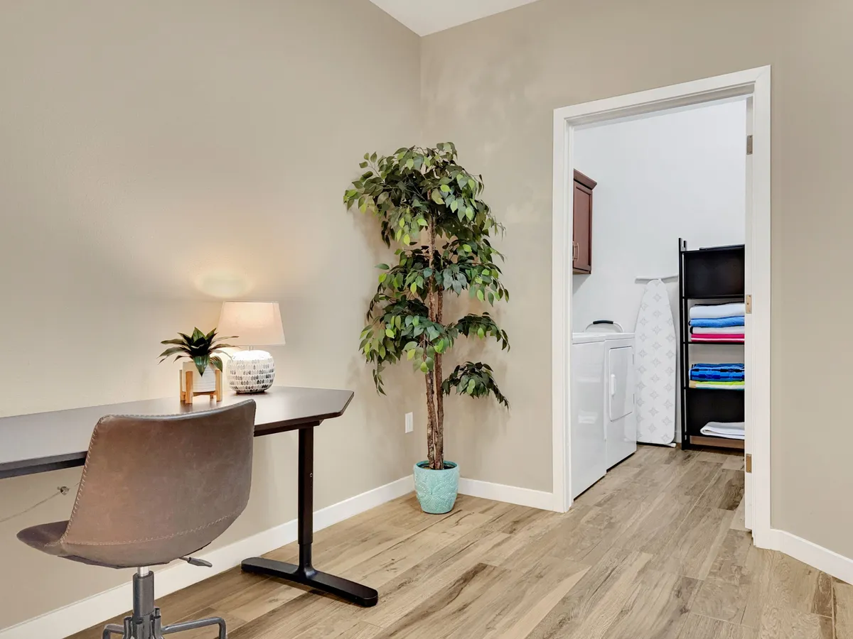 A modern fitness center filled with state-of-the-art treadmills, rowing machines, and exercise bikes sits under large windows, letting in abundant natural light. The open layout fosters a motivational and energetic atmosphere for residents to exercise or join group fitness activities.